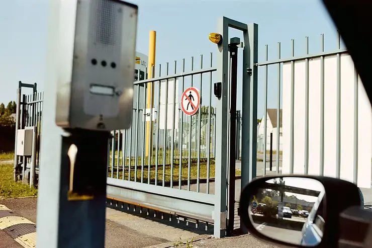 A gate security stop for a key card from inside a car